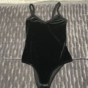 First class black velvet bodysuit.